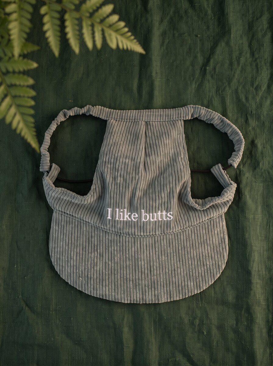 Just Woofin' green corduroy dog hat with white embroidery on cream linen with eucalyptus